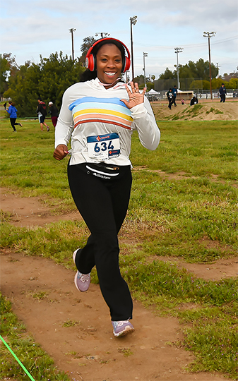 A happy race participant wearing red headphones